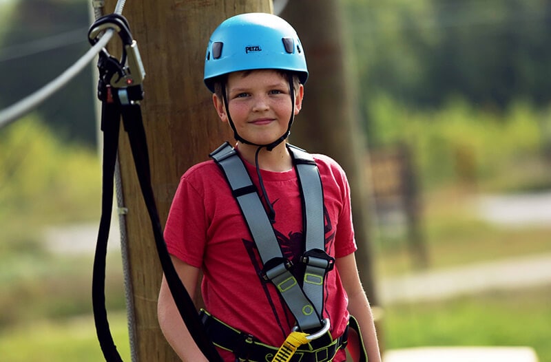 Smiling boy on the adventure park course