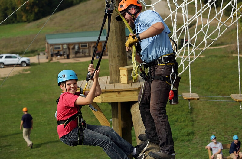 Man and boy on adventure park course