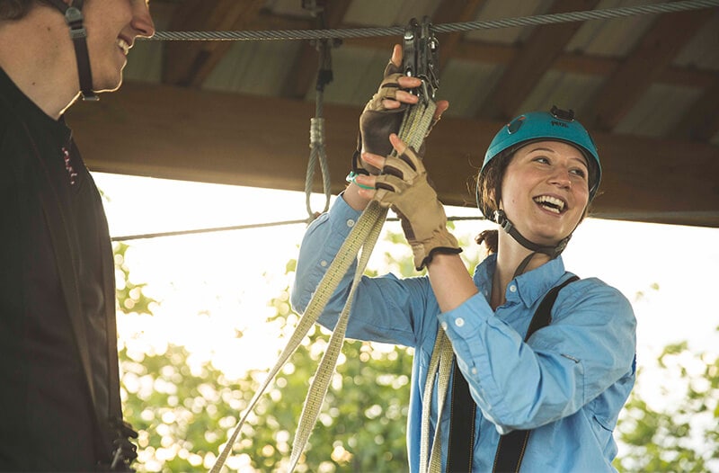 Women happily prepares the zipline