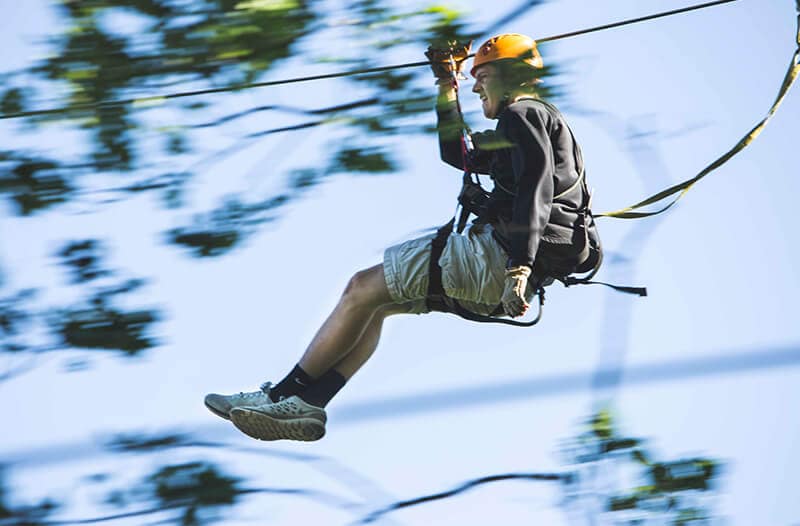 Boy zipliner flies through the air fast
